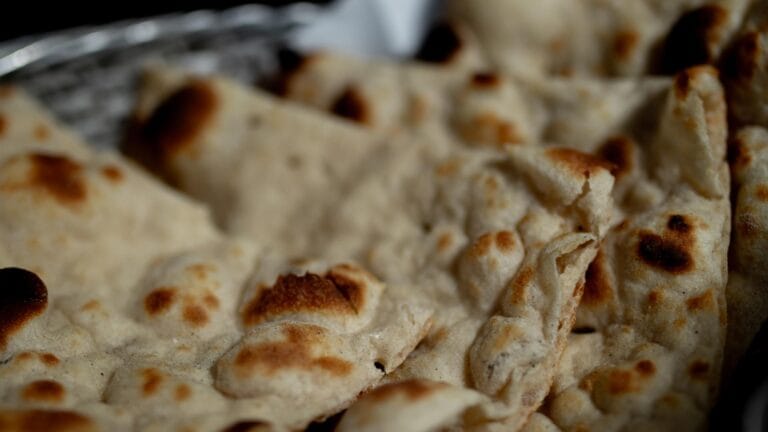 Naan bread cooking in a traditional tandoor