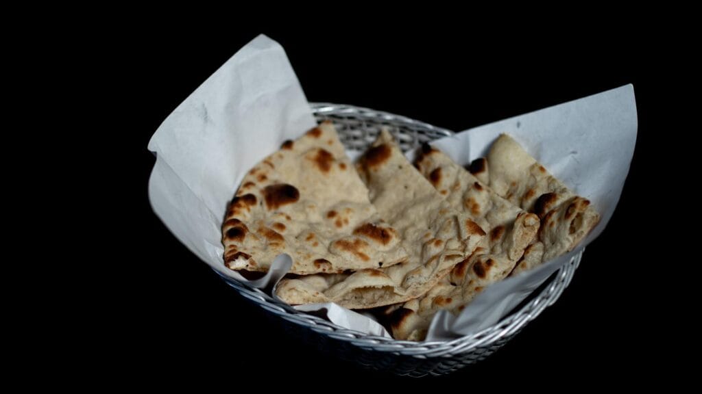 Fresh naan bread served with an Indian meal